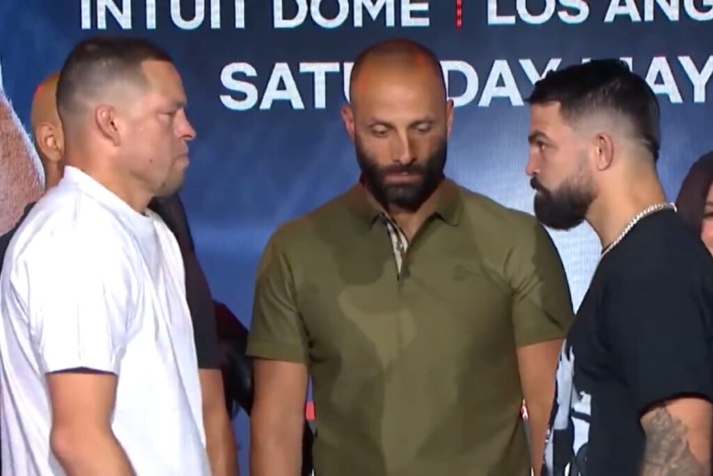 Nate Diaz y Jorge Masvidal cara a cara. Un mediador los separa en rueda de prensa del combate.