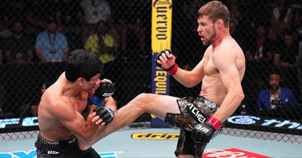 Dos luchadores de MMA en un combate intenso. Uno lanza una patada a la pierna del oponente dentro de la jaula, con guantes de UFC.