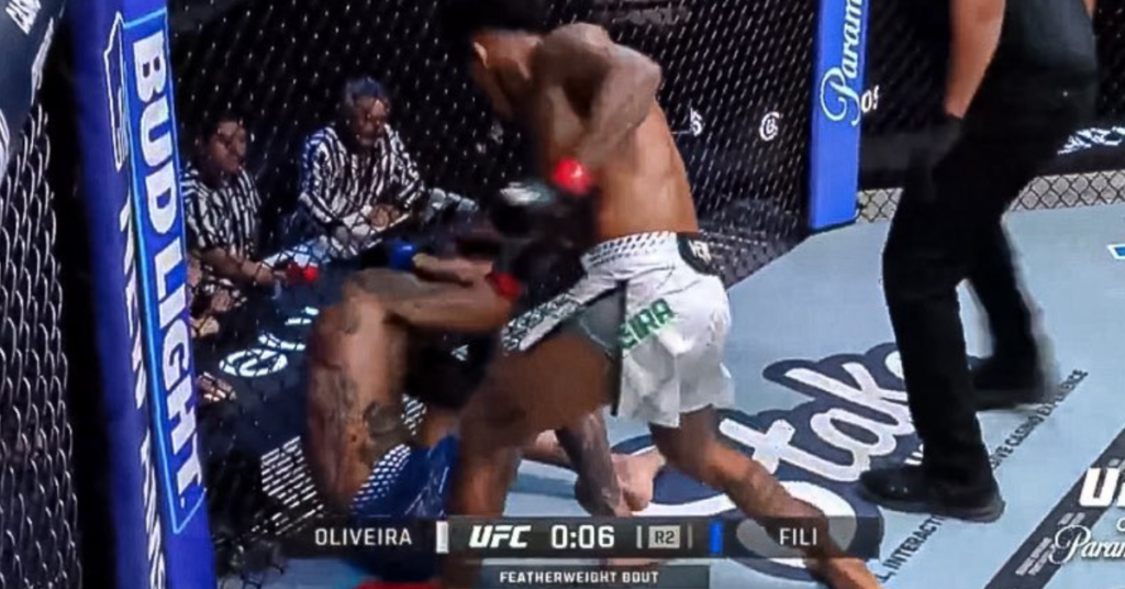 Pelea de UFC: Oliveira en el suelo recibiendo golpes de Fili en el octágono, con el marcador "0:06 R2" y Bud Light.