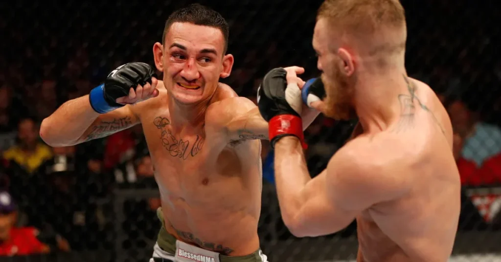 Intenso combate de MMA: Max Holloway, con heridas faciales, lanza un golpe a Conor McGregor en el octágono.